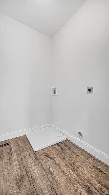 149 Haven Ridge Ct, Dardenne Prairie, MO 63368 - clothes washing area with electric dryer hookup, washer hookup, wood finished floors, and baseboards