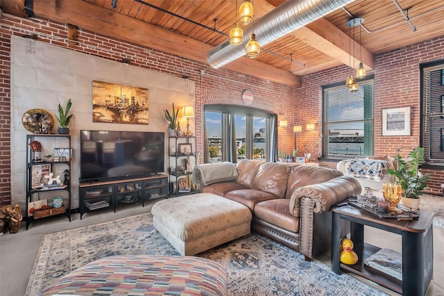 living room with brick wall, wooden ceiling, concrete flooring, and beam ceiling