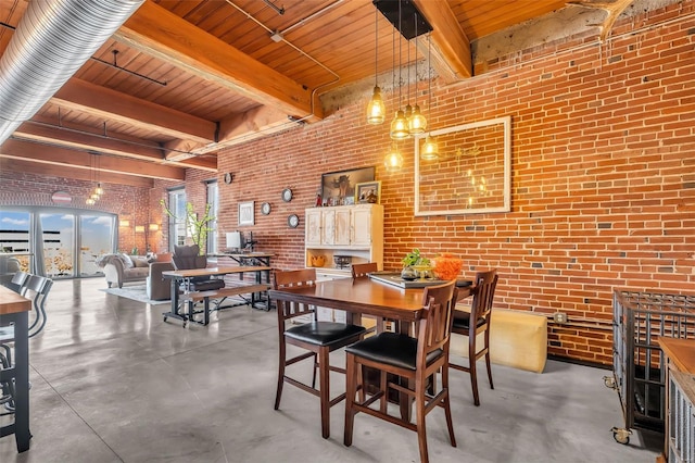 dining space featuring brick wall, wood ceiling, concrete floors, and beamed ceiling