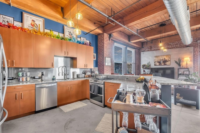 kitchen with appliances with stainless steel finishes, a sink, wooden ceiling, concrete flooring, and light stone countertops