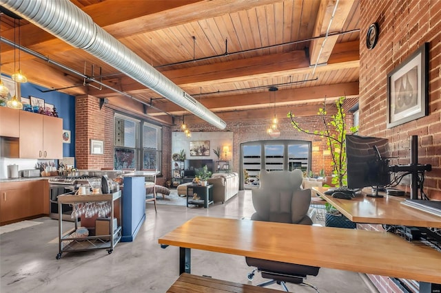 office area featuring brick wall and finished concrete floors