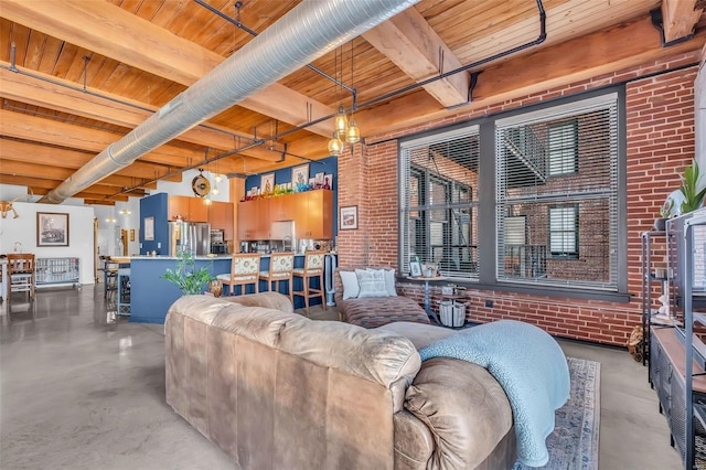 living area featuring wooden ceiling, finished concrete flooring, beamed ceiling, and brick wall