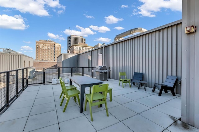 view of patio / terrace with a grill, outdoor dining space, and a balcony