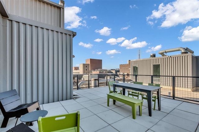 view of patio with outdoor dining area and a balcony