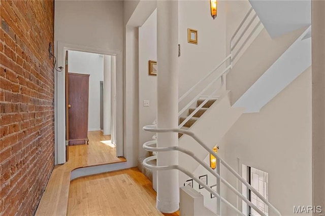 1906 Lasalle St, Saint Louis, MO 63104 - hallway with brick wall, wood finished floors, and stairway