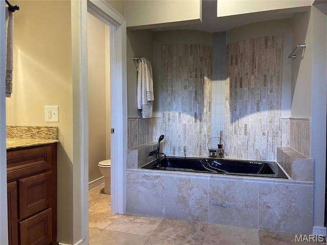 1906 Lasalle St, Saint Louis, MO 63104 - bathroom featuring toilet, a relaxing tiled tub, and vanity
