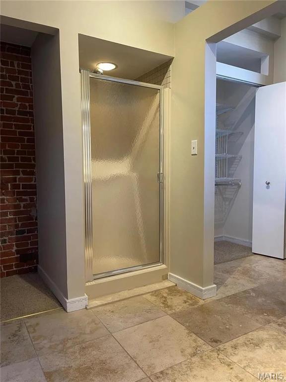 1906 Lasalle St, Saint Louis, MO 63104 - full bathroom featuring baseboards, a stall shower, and stone finish floors
