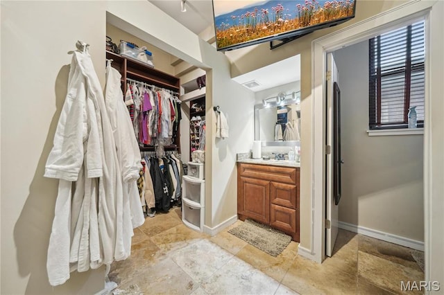 1906 Lasalle St, Saint Louis, MO 63104 - bathroom featuring vanity, a walk in closet, and baseboards