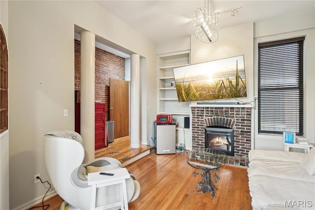 1906 Lasalle St, Saint Louis, MO 63104 - living area featuring a fireplace, built in features, wood finished floors, and baseboards