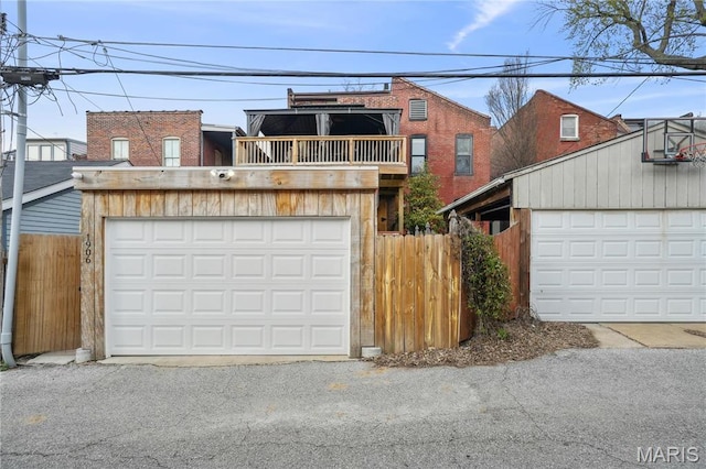 1906 Lasalle St, Saint Louis, MO 63104 - view of front facade featuring a balcony, fence, and a garage