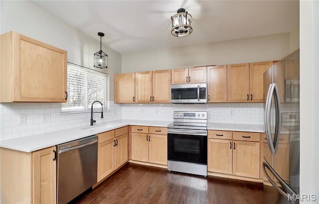 460 Fortress Ct, Saint Charles, MO 63303 - kitchen featuring stainless steel appliances, light brown cabinets, a sink, and light countertops