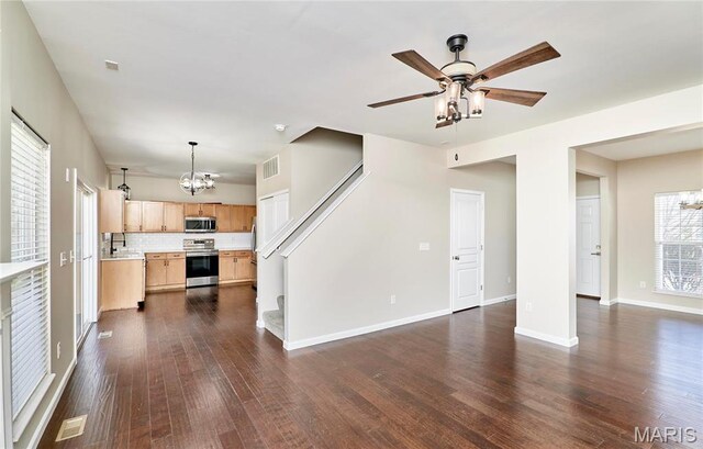 460 Fortress Ct, Saint Charles, MO 63303 - unfurnished living room featuring a chandelier, dark wood finished floors, a ceiling fan, and baseboards