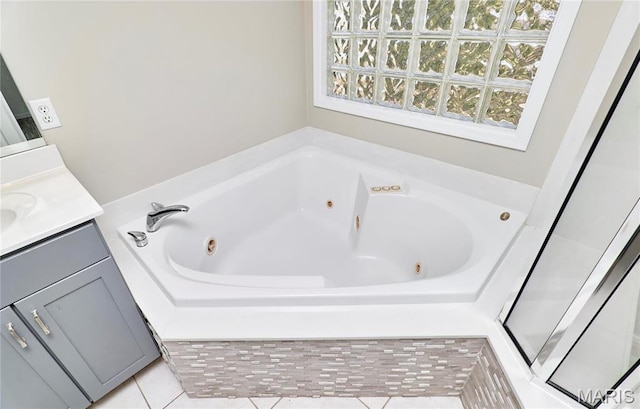 460 Fortress Ct, Saint Charles, MO 63303 - bathroom with vanity, a jetted tub, and tile patterned flooring