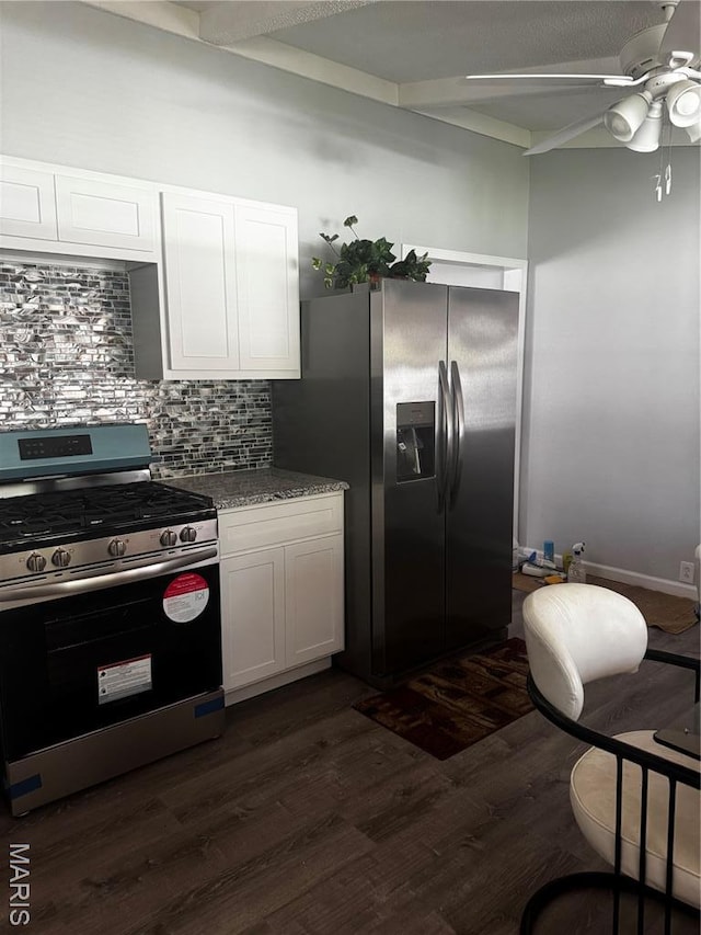 kitchen featuring appliances with stainless steel finishes, tasteful backsplash, dark wood finished floors, white cabinets, and ceiling fan