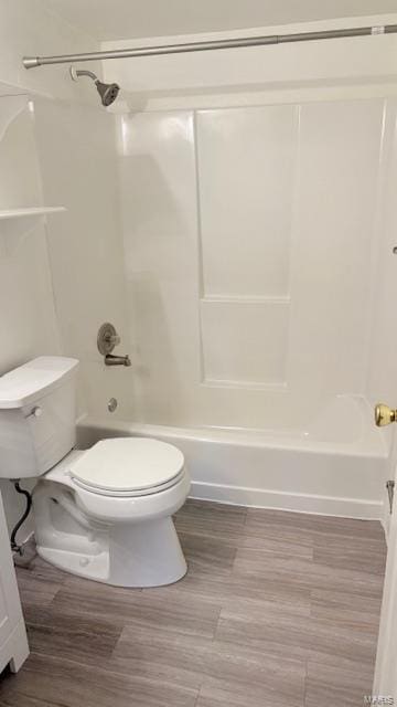 full bathroom featuring toilet, shower / bath combination, and wood finished floors