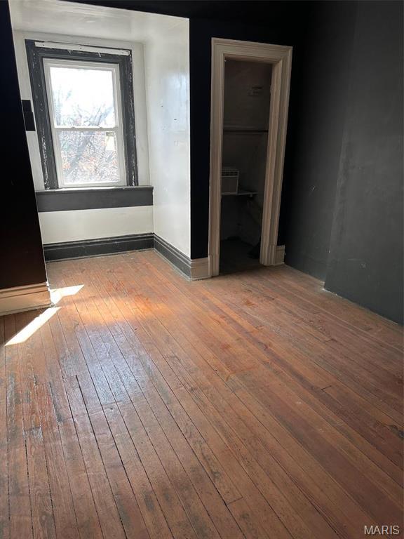 2643 Gravois Ave, Saint Louis, MO 63118 - unfurnished bedroom featuring wood-type flooring and baseboards