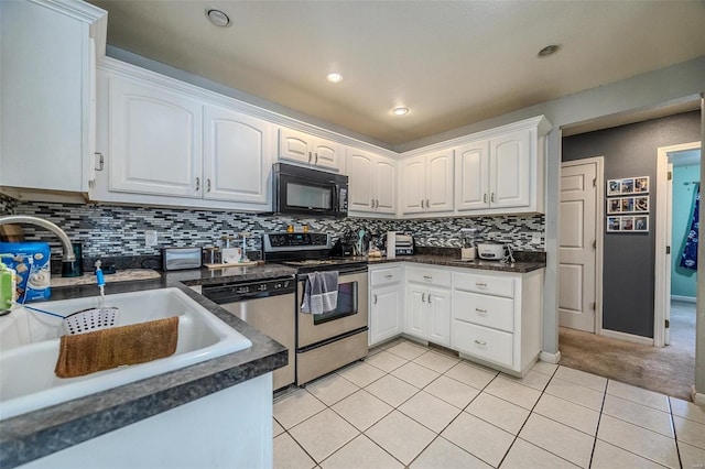 735 Dale Ln, Richland, MO 65556 - kitchen with appliances with stainless steel finishes, a sink, dark countertops, light tile patterned flooring, and recessed lighting