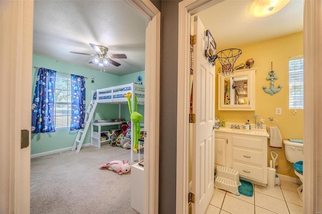 735 Dale Ln, Richland, MO 65556 - bedroom featuring baseboards, a sink, a ceiling fan, and light colored carpet