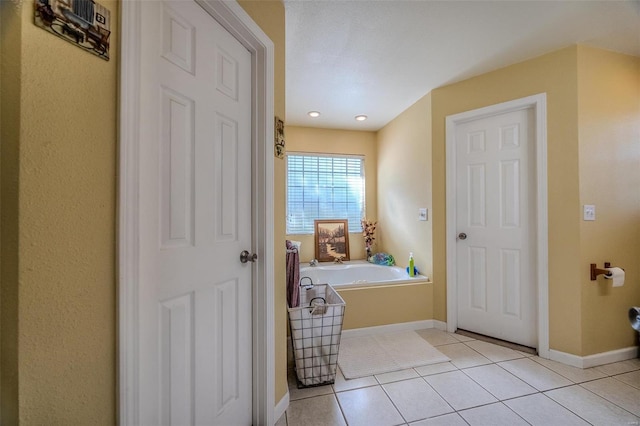 735 Dale Ln, Richland, MO 65556 - bathroom with a bath, tile patterned floors, and baseboards