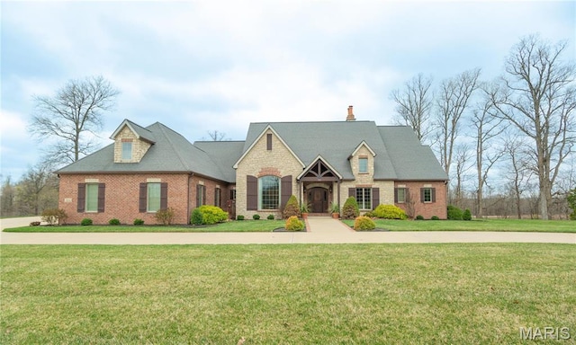 334 Trillium Ln, Cape Girardeau, MO 63701 - view of front of home with a front yard, brick siding, and a chimney