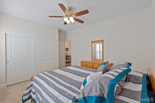 bedroom with carpet flooring, a closet, and ceiling fan