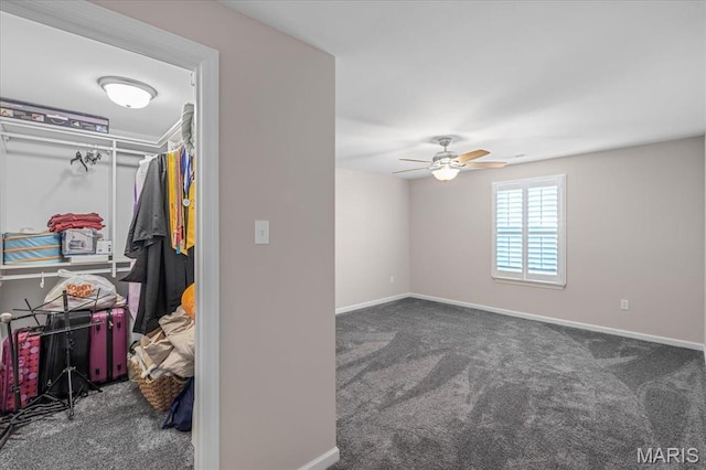 unfurnished bedroom with carpet floors, baseboards, and a ceiling fan
