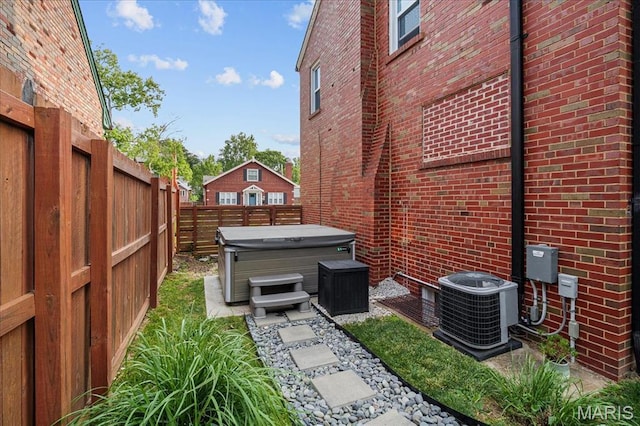 7334 Chamberlain Ave, Saint Louis, MO 63130 - fenced backyard featuring a hot tub and central AC