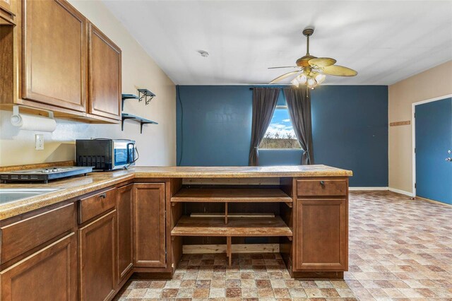 6400 Hoot Owl Ln, French Village, MO 63036 - kitchen with ceiling fan, open shelves, a peninsula, light countertops, and a desk