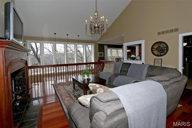 589 Wetherby Terrace Dr, Ballwin, MO 63021 - living room featuring a chandelier, high vaulted ceiling, wood finished floors, and a high end fireplace