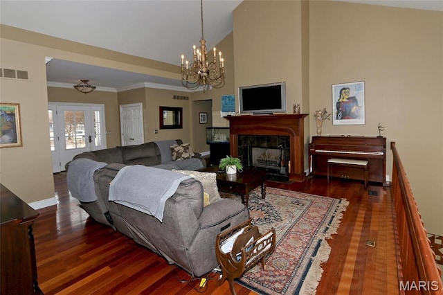589 Wetherby Terrace Dr, Ballwin, MO 63021 - living area with a chandelier, wood finished floors, a high end fireplace, ornamental molding, and vaulted ceiling