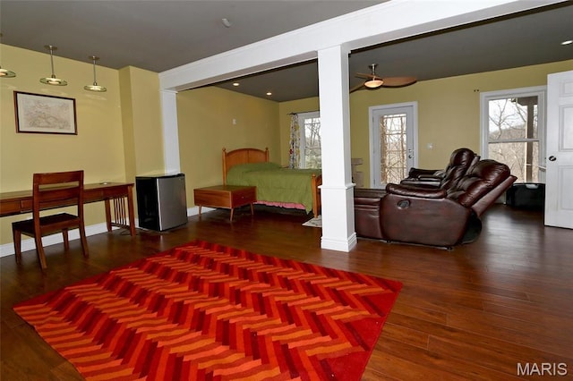 589 Wetherby Terrace Dr, Ballwin, MO 63021 - living area with decorative columns, wood finished floors, ceiling fan, and baseboards