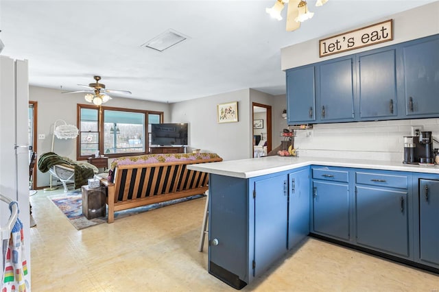 9449 E Lake View Dr, Bonne Terre, MO 63628 - kitchen featuring blue cabinets, a peninsula, light countertops, and tasteful backsplash