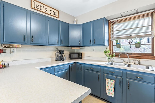 9449 E Lake View Dr, Bonne Terre, MO 63628 - kitchen with a sink, blue cabinets, black microwave, backsplash, and light countertops