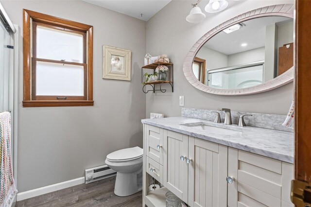 9449 E Lake View Dr, Bonne Terre, MO 63628 - full bath with a baseboard heating unit, wood finished floors, a stall shower, toilet, and vanity