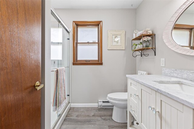 9449 E Lake View Dr, Bonne Terre, MO 63628 - full bath with a baseboard radiator, wood finished floors, a stall shower, toilet, and vanity