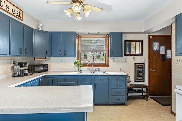 9449 E Lake View Dr, Bonne Terre, MO 63628 - kitchen with a sink, blue cabinetry, black microwave, light countertops, and backsplash