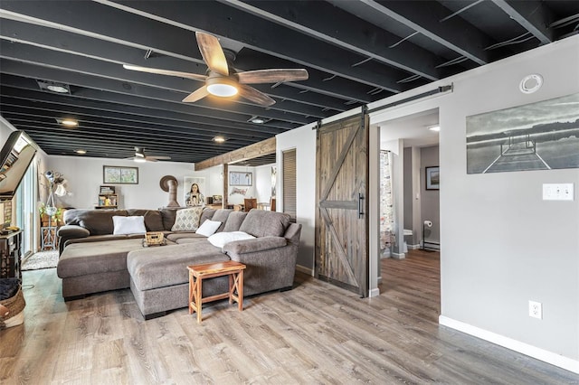 9449 E Lake View Dr, Bonne Terre, MO 63628 - living room with a barn door, a ceiling fan, wood finished floors, and baseboards