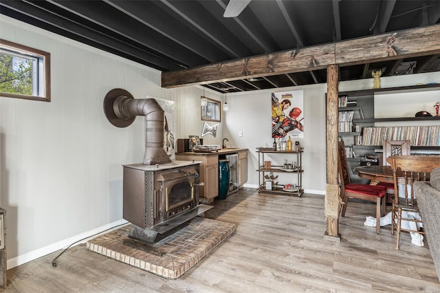 9449 E Lake View Dr, Bonne Terre, MO 63628 - below grade area featuring a wood stove, light wood-type flooring, and baseboards