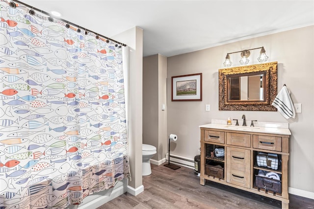 9449 E Lake View Dr, Bonne Terre, MO 63628 - full bathroom featuring wood finished floors, baseboards, baseboard heating, toilet, and vanity