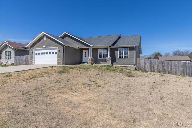 151 Alisha Ave, Poplar Bluff, MO 63901 - view of front facade featuring fence, a garage, concrete driveway, and stone siding
