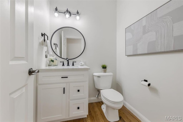 3724 Nadler Rd, Mo, MO 63385 - bathroom with toilet, wood finished floors, baseboards, and vanity