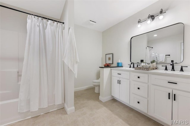 3724 Nadler Rd, Mo, MO 63385 - full bath featuring toilet, shower / tub combo with curtain, double vanity, and baseboards
