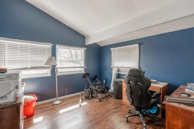 office area featuring vaulted ceiling, wood finished floors, a textured ceiling, and baseboards