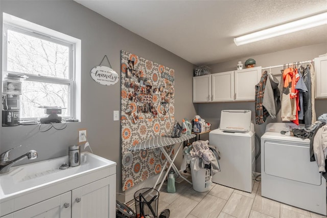 laundry room with cabinet space and washer and clothes dryer