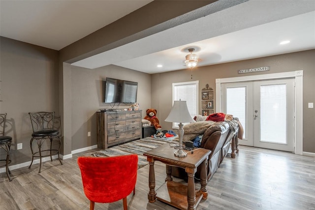 living area with wood finished floors, baseboards, ceiling fan, french doors, and recessed lighting