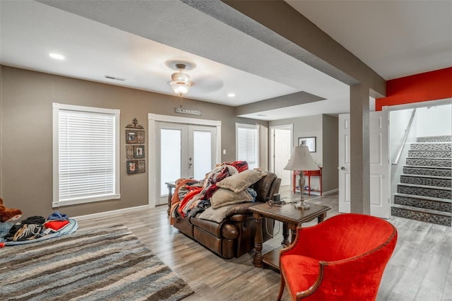 living room with stairs, french doors, wood finished floors, baseboards, and recessed lighting