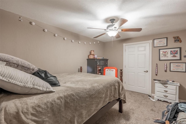 bedroom featuring light colored carpet and a ceiling fan
