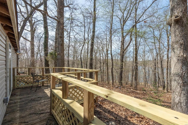 wooden deck with a forest view