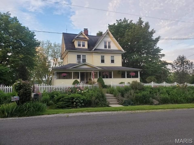 708 E Fillmore St E, Fillmore, IL 62032 - victorian-style house with fence, a porch, and a chimney
