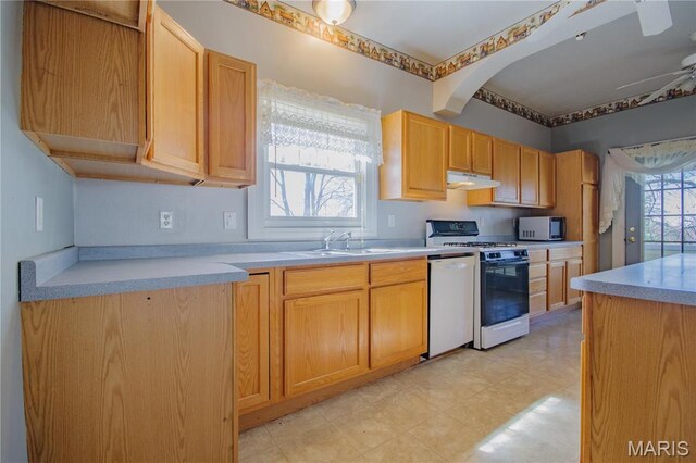 708 E Fillmore St E, Fillmore, IL 62032 - kitchen with white appliances, under cabinet range hood, a sink, light countertops, and light brown cabinets